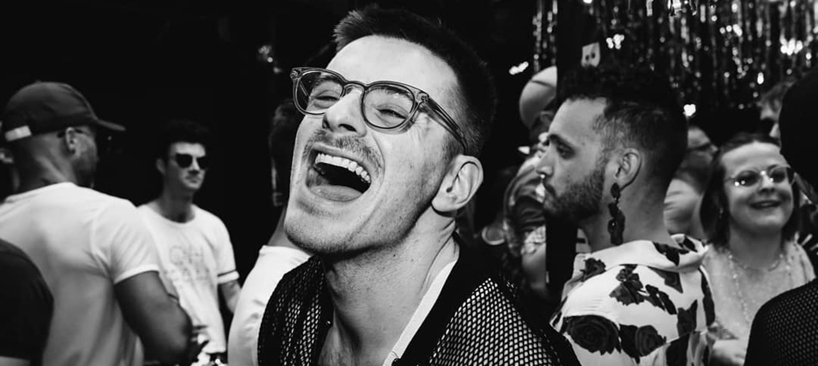 Chris laughing at a party in Melbourne